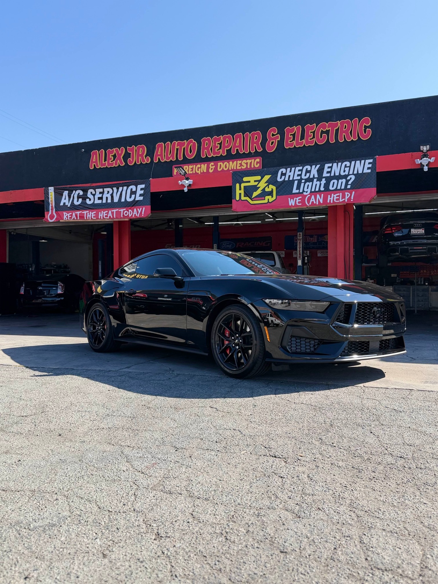 Alex Jr's shop front with vehicle