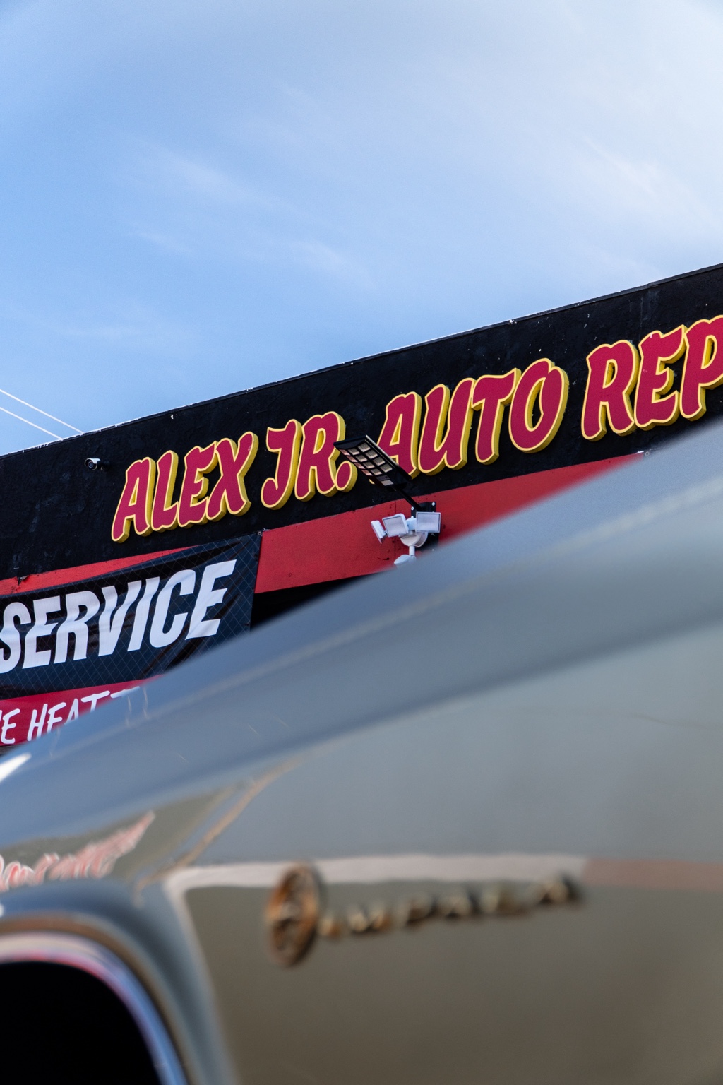 Close-up of Alex Jr's Auto Repair & Electric shop sign